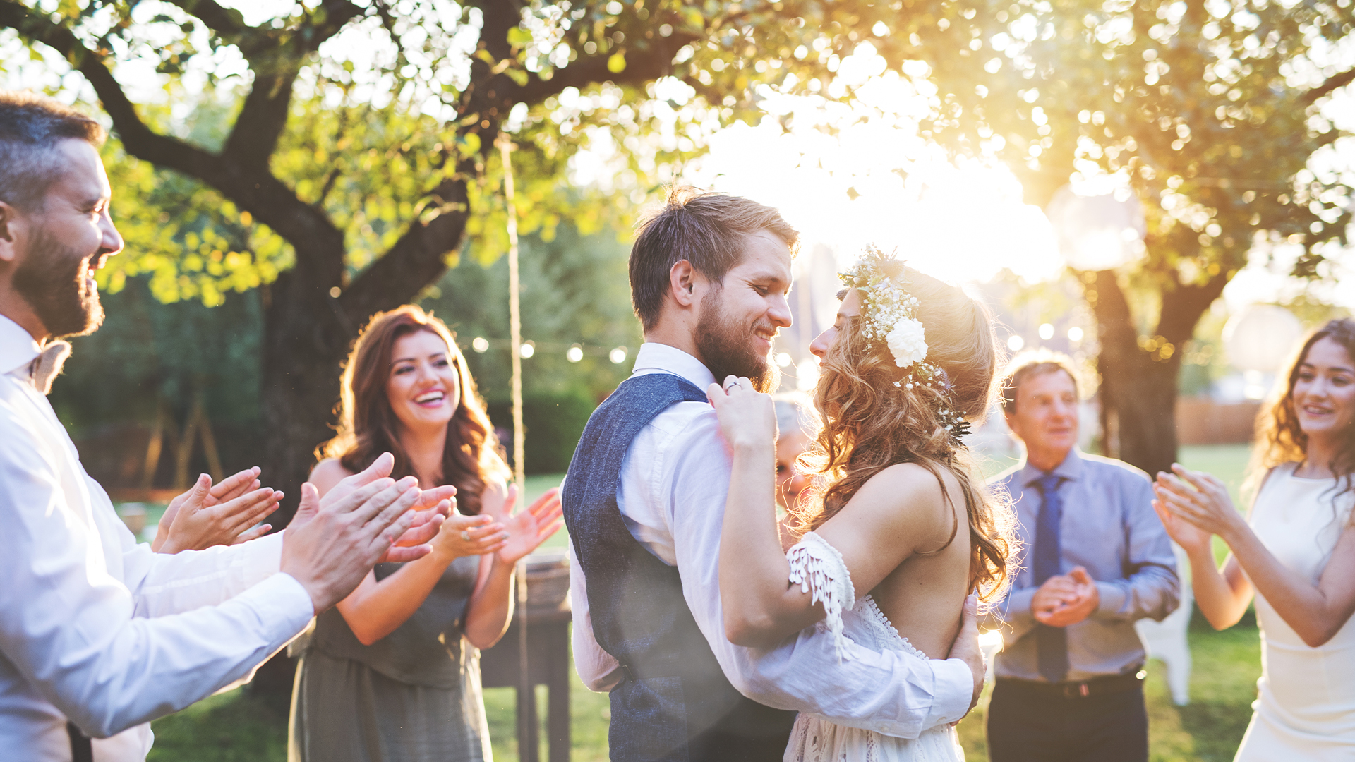 Bride and groom dancing at wedding reception outside in the backyard