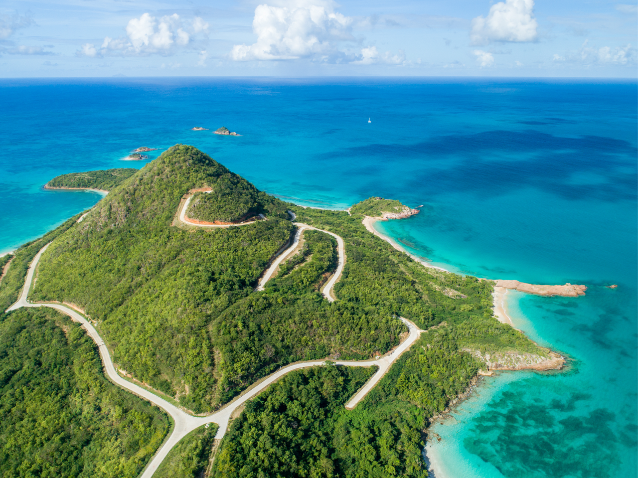 An aerial shot of Pearns Point, surrounded by the crystal-clear ocean. 
