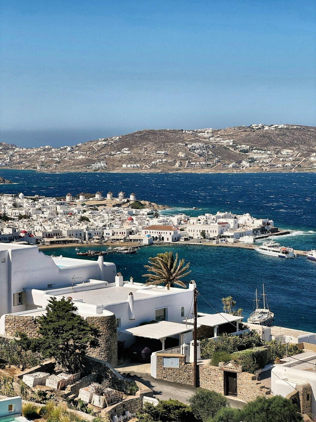 Aerial view of a whitewashed Cycladic town by the sea